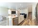 Open kitchen with white cabinetry, stainless steel appliances, and wood flooring at 4517 Swimming Minnow Ave, Las Vegas, NV 89141