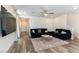 Spacious living room featuring wood floors, comfortable seating, and contemporary decor at 4517 Swimming Minnow Ave, Las Vegas, NV 89141