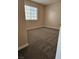 A cozy bedroom featuring neutral carpet and a large window, perfect for relaxing and resting at 4720 Krissylouise Way, Las Vegas, NV 89121