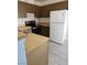 Functional kitchen with brown cabinets and a white refrigerator, ready for your culinary creations at 4720 Krissylouise Way, Las Vegas, NV 89121