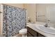 Bathroom featuring a toilet with a blue patterned shower curtain and a sink at 4902 Guysborough St, Las Vegas, NV 89148
