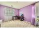 Bright bedroom with purple walls, carpeted floor, desk, and sheer curtains at 4902 Guysborough St, Las Vegas, NV 89148