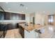 Spacious kitchen featuring an island with granite countertops, stainless steel appliances, and dark wood cabinetry at 4902 Guysborough St, Las Vegas, NV 89148