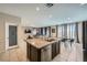 Open kitchen with island and stainless steel dishwasher, connecting to living area at 4902 Guysborough St, Las Vegas, NV 89148