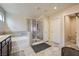Bright bathroom with tile flooring, large glass shower, and soaking tub next to shower at 4902 Guysborough St, Las Vegas, NV 89148