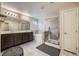 Bright bathroom featuring tile flooring, dual sink vanity, soaking tub and glass enclosed shower at 4902 Guysborough St, Las Vegas, NV 89148