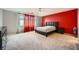 Spacious main bedroom with a black leather headboard, carpet flooring, and bright windows at 4902 Guysborough St, Las Vegas, NV 89148