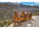 Aerial view of log cabin home with mountain backdrop, showcasing its unique charm and location at 4927 Snow White Rd, Las Vegas, NV 89124