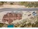 Aerial view showcases the home's unique roofline and its setting amidst a natural desert landscape at 4927 Snow White Rd, Las Vegas, NV 89124