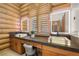Luxurious log cabin bathroom features dual marble sinks and a vanity with plenty of storage at 4927 Snow White Rd, Las Vegas, NV 89124