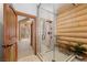 This bathroom is a log cabin design with stand up shower and a view into another bedroom at 4927 Snow White Rd, Las Vegas, NV 89124