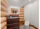 Powder room with natural wood vanity and modern toilet in a log-walled space at 4927 Snow White Rd, Las Vegas, NV 89124