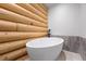 This log cabin bathroom is newly renovated with a luxurious free standing tub and neutral tiling at 4927 Snow White Rd, Las Vegas, NV 89124