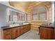 Bathroom featuring double sink vanity, stone countertops, and modern lighting at 4927 Snow White Rd, Las Vegas, NV 89124