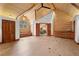 Bedroom showcasing log walls, vaulted ceilings, and wood floors at 4927 Snow White Rd, Las Vegas, NV 89124