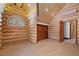 Bedroom showcasing log walls, vaulted ceilings, and a view of the backyard at 4927 Snow White Rd, Las Vegas, NV 89124