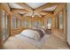 This bedroom is a log cabin design with light hardwood floors and lots of natural light at 4927 Snow White Rd, Las Vegas, NV 89124