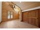 Bright bedroom boasting log walls, vaulted ceilings, and wood floors at 4927 Snow White Rd, Las Vegas, NV 89124