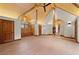Spacious bedroom featuring wood beam ceiling, log walls, and hardwood floors at 4927 Snow White Rd, Las Vegas, NV 89124