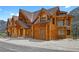 Exterior shot of log cabin home with unique architectural details and beautiful mountain views at 4927 Snow White Rd, Las Vegas, NV 89124