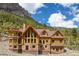 Beautiful exterior view of custom log home, nestled in a picturesque mountain setting at 4927 Snow White Rd, Las Vegas, NV 89124