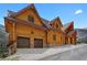Exterior elevation of log cabin home with a two-car garage and a beautiful stacked stone foundation at 4927 Snow White Rd, Las Vegas, NV 89124