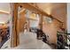 Interior hallway with unique railings, log beams, and high ceilings at 4927 Snow White Rd, Las Vegas, NV 89124
