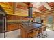 Gourmet kitchen boasts modern appliances, a center island with bar seating, and log beam accents at 4927 Snow White Rd, Las Vegas, NV 89124