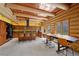 This log home kitchen features wood cabinets, a chef's island, and a large dining table with great views at 4927 Snow White Rd, Las Vegas, NV 89124