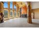 Living room features a stone fireplace, high ceilings, and abundant natural light from large windows at 4927 Snow White Rd, Las Vegas, NV 89124