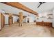 Bright living area with hardwood floors, wooden beams, custom shelving, and staircase at 4927 Snow White Rd, Las Vegas, NV 89124