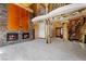 This log home offers a stone fireplace, wood beams, and an open staircase at 4927 Snow White Rd, Las Vegas, NV 89124