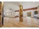 Spacious living room featuring hardwood floors, wooden beams and decorative log pillars at 4927 Snow White Rd, Las Vegas, NV 89124