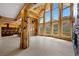 Spacious living room features floor to ceiling windows, log columns and views of the mountains at 4927 Snow White Rd, Las Vegas, NV 89124