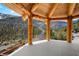 Mountain views from log-beamed patio with stone flooring and wood railing at 4927 Snow White Rd, Las Vegas, NV 89124