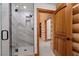 Modern walk-in shower featuring sleek glass doors and marble tile design at 4927 Snow White Rd, Las Vegas, NV 89124