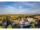 Panoramic aerial view of a two-story home, lush landscaping, and a cityscape skyline with scenic mountains in the background at 4944 Spanish Heights Dr, Las Vegas, NV 89148