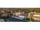 An aerial view showcasing a two-story home with red tile roof, three-car garage, and lush landscaping in a gated community at 4944 Spanish Heights Dr, Las Vegas, NV 89148