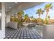 Spacious balcony with a patterned floor offering beautiful views of palm trees and tennis courts at 4944 Spanish Heights Dr, Las Vegas, NV 89148