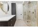 Modern bathroom with floating vanity, gold fixtures and tile enclosed shower at 4944 Spanish Heights Dr, Las Vegas, NV 89148