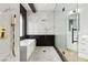 Luxurious bathroom featuring a soaking tub, rainfall shower, and elegant black and white tile at 4944 Spanish Heights Dr, Las Vegas, NV 89148