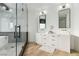 Bright bathroom with a dual sink vanity, modern fixtures, and a glass enclosed shower at 4944 Spanish Heights Dr, Las Vegas, NV 89148