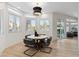 Charming dining area featuring a round table, stylish chairs, and natural light from surrounding windows at 4944 Spanish Heights Dr, Las Vegas, NV 89148