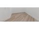 Clean, empty room with light wood-look flooring and white baseboards at 4944 Spanish Heights Dr, Las Vegas, NV 89148