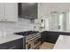 Modern kitchen featuring high-end appliances, granite countertops, and ample cabinetry at 4944 Spanish Heights Dr, Las Vegas, NV 89148