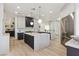 A modern kitchen features a waterfall island, stainless appliances, and custom cabinetry at 4944 Spanish Heights Dr, Las Vegas, NV 89148