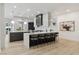 Modern kitchen with stainless steel appliances, gray cabinets, a waterfall island, and wood floors at 4944 Spanish Heights Dr, Las Vegas, NV 89148