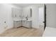 Bright laundry room with ample storage space and light wood-look floors at 4944 Spanish Heights Dr, Las Vegas, NV 89148