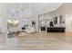 Open living room featuring high ceilings, a stylish sofa, and a modern kitchen with an island at 4944 Spanish Heights Dr, Las Vegas, NV 89148