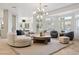 Bright living room features a round sofa, area rug, and ample natural light from the large windows at 4944 Spanish Heights Dr, Las Vegas, NV 89148